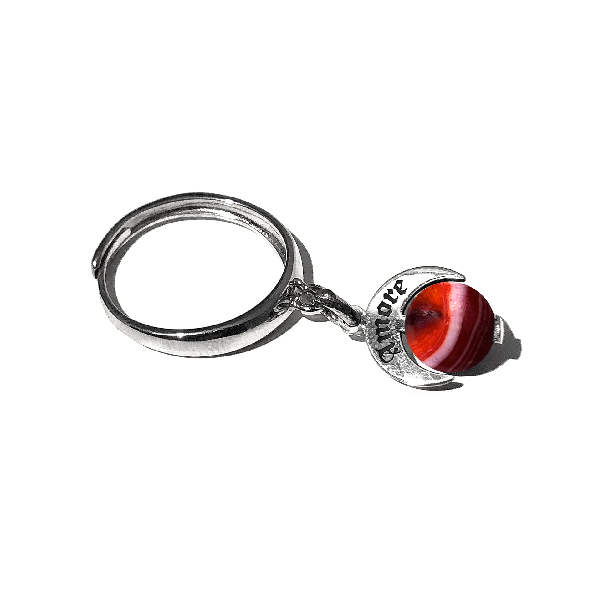 Caratteristiche: L'anello è composto da una base in Argento 925 e un Charm Naja. Quest'ultimo è inciso e smaltato, con scritte in carattere gotico e una Pietra Dura. Il Charm è attaccato alla base dell'anello con un piccolo moschettone che permette l'eventuale riposizionamento del charm stesso su un bracciale , una collana o un qualsiasi altro supporto