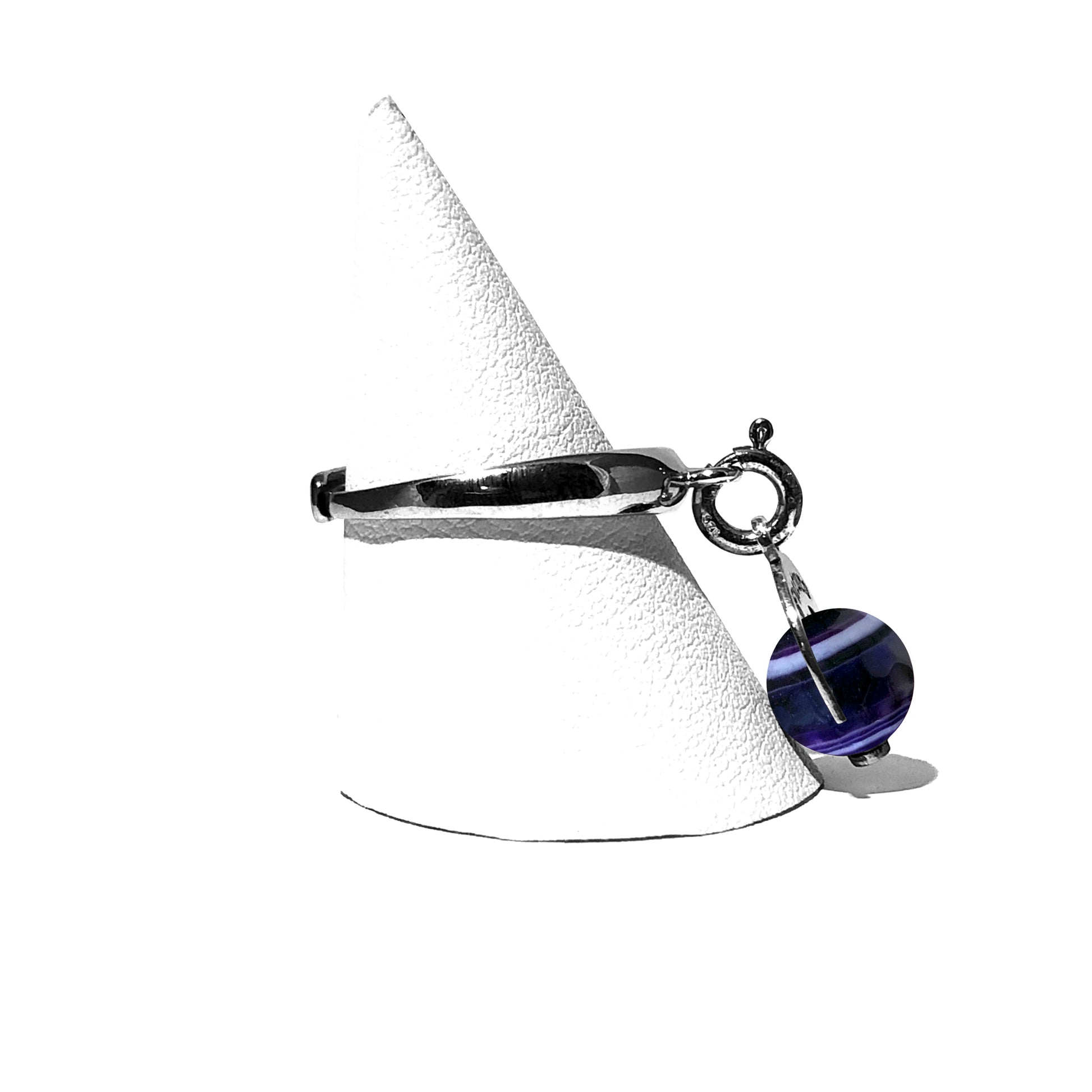 Caratteristiche: L'anello è composto da una base in Argento 925 e un Charm Naja. Quest'ultimo è inciso e smaltato, con scritte in carattere gotico e una Pietra Dura. Il Charm è attaccato alla base dell'anello con un piccolo moschettone che permette l'eventuale riposizionamento del charm stesso su un bracciale , una collana o un qualsiasi altro supporto